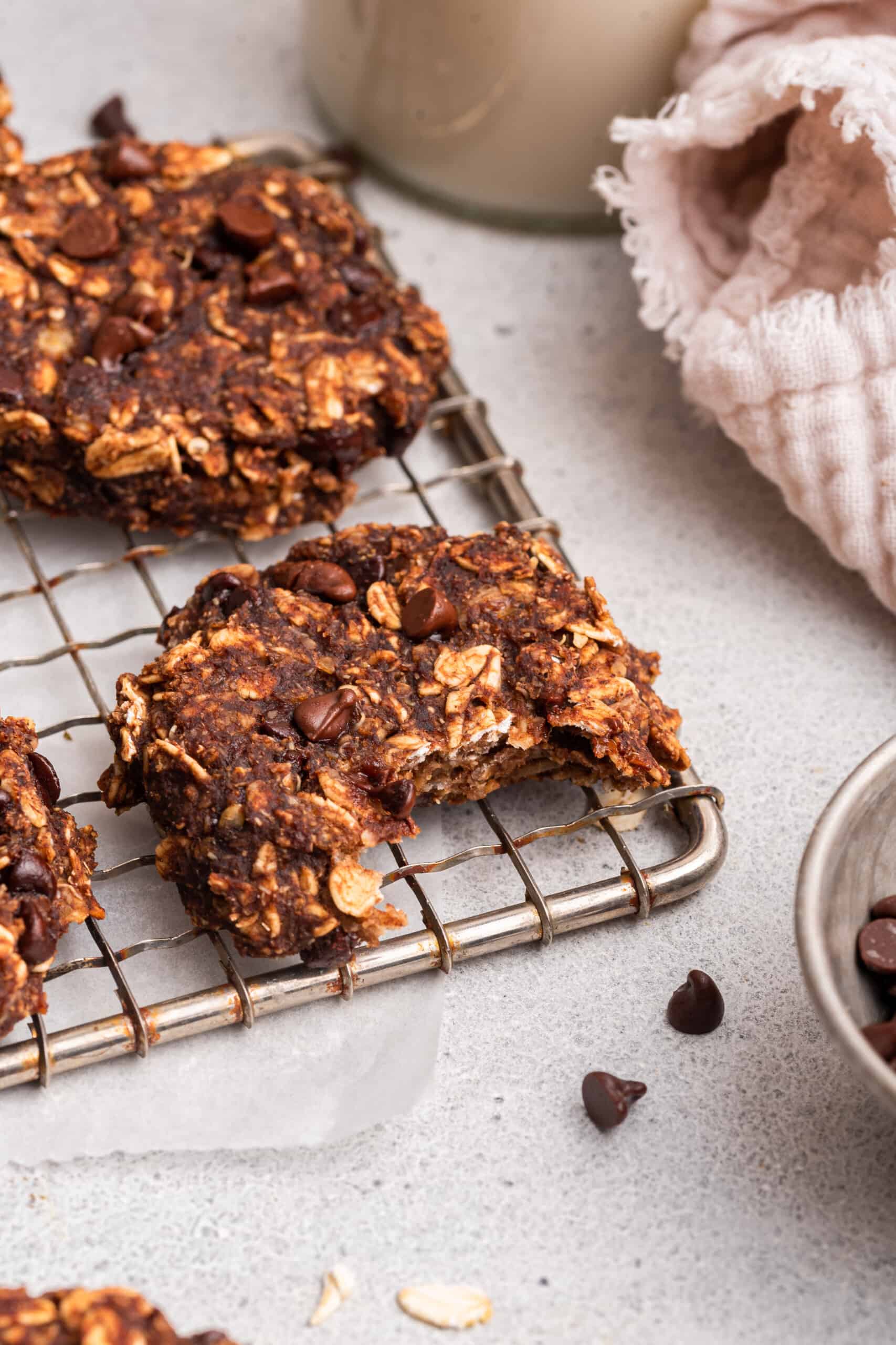 Half-eaten banana oatmeal cookie on wire rack