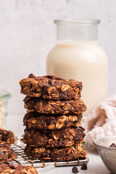 5 banana oatmeal cookies stacked on wire cooling rack