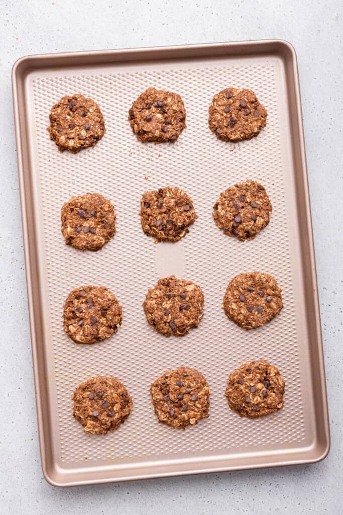 Overhead view of banana oatmeal cookies on baking sheet before baking