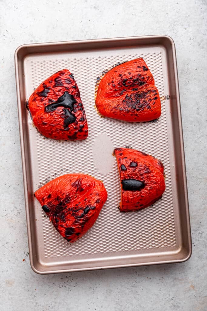 Roasted red peppers on baking sheet