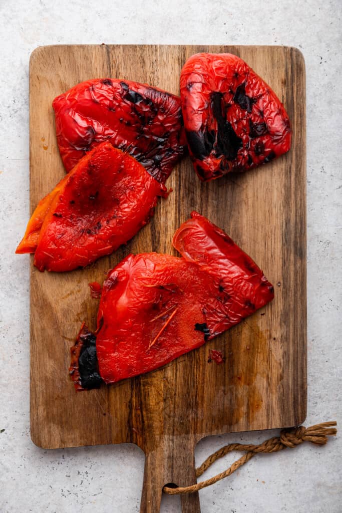 Roasted red peppers on cutting board