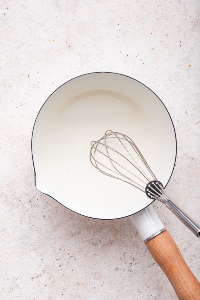 Overhead view of vinegar mixture in pan with whisk