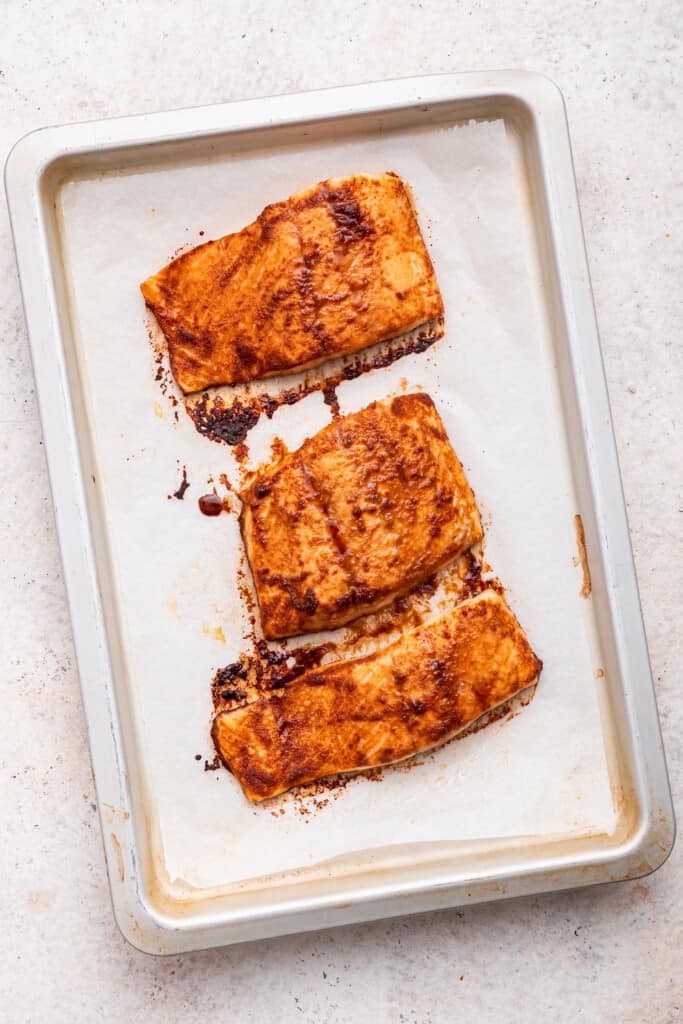 Overhead view of baked salmon on pan