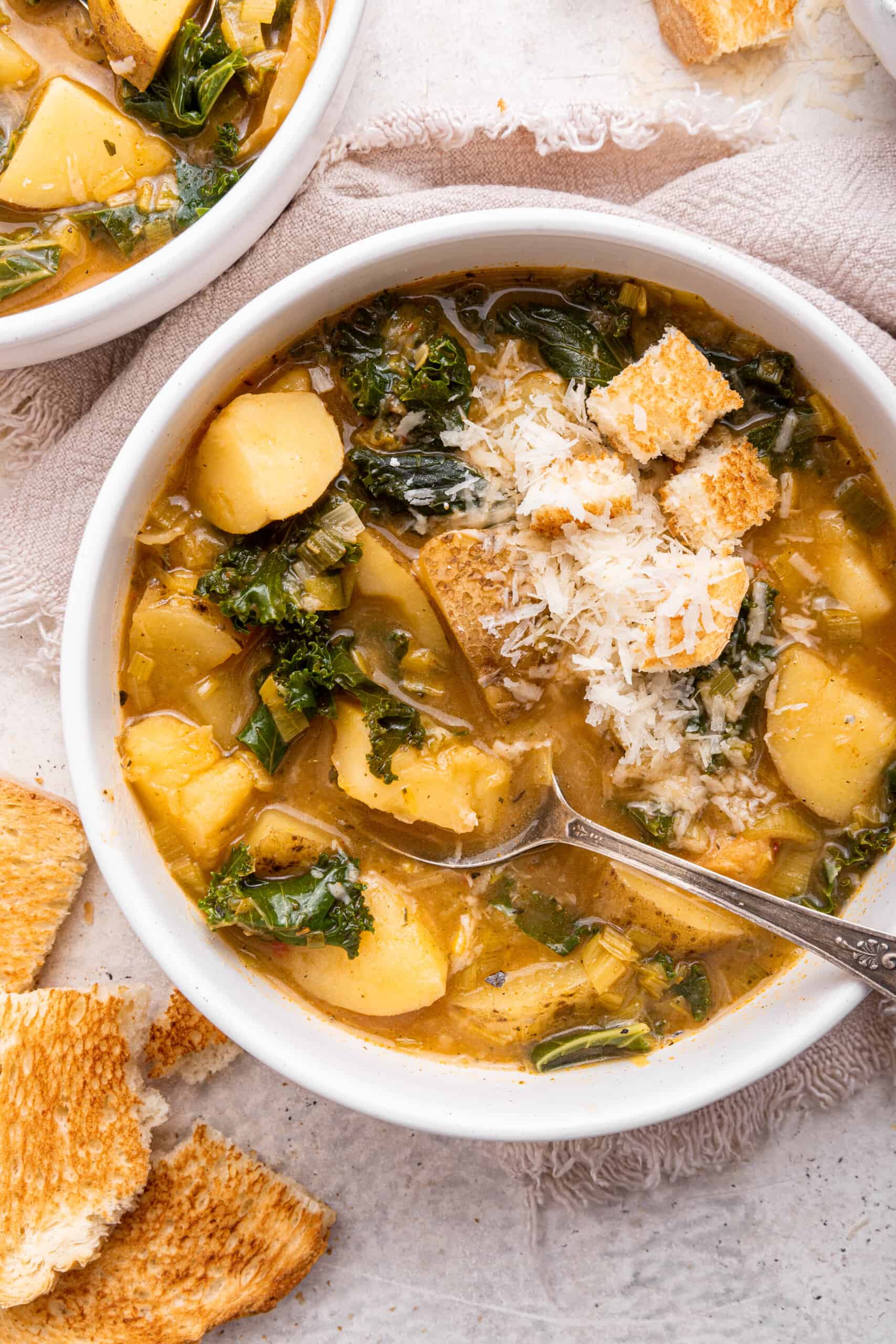 Bowl of vegan potato soup with spoon
