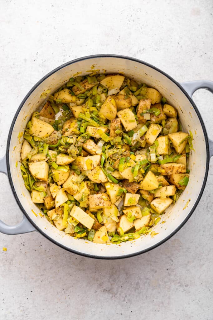 Potatoes and leeks in pot for vegan potato soup