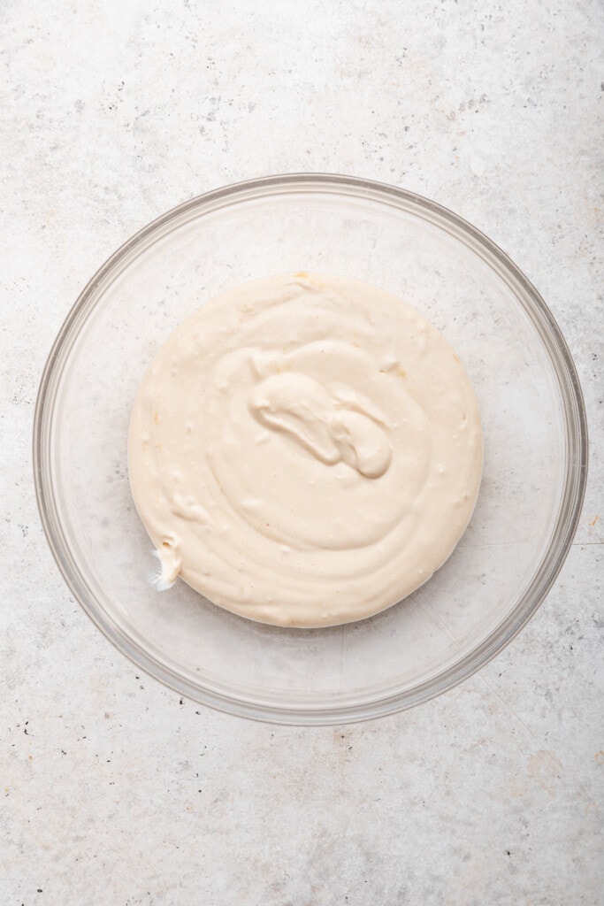 Overhead view of pureed cottage cheese mixture in glass bowl