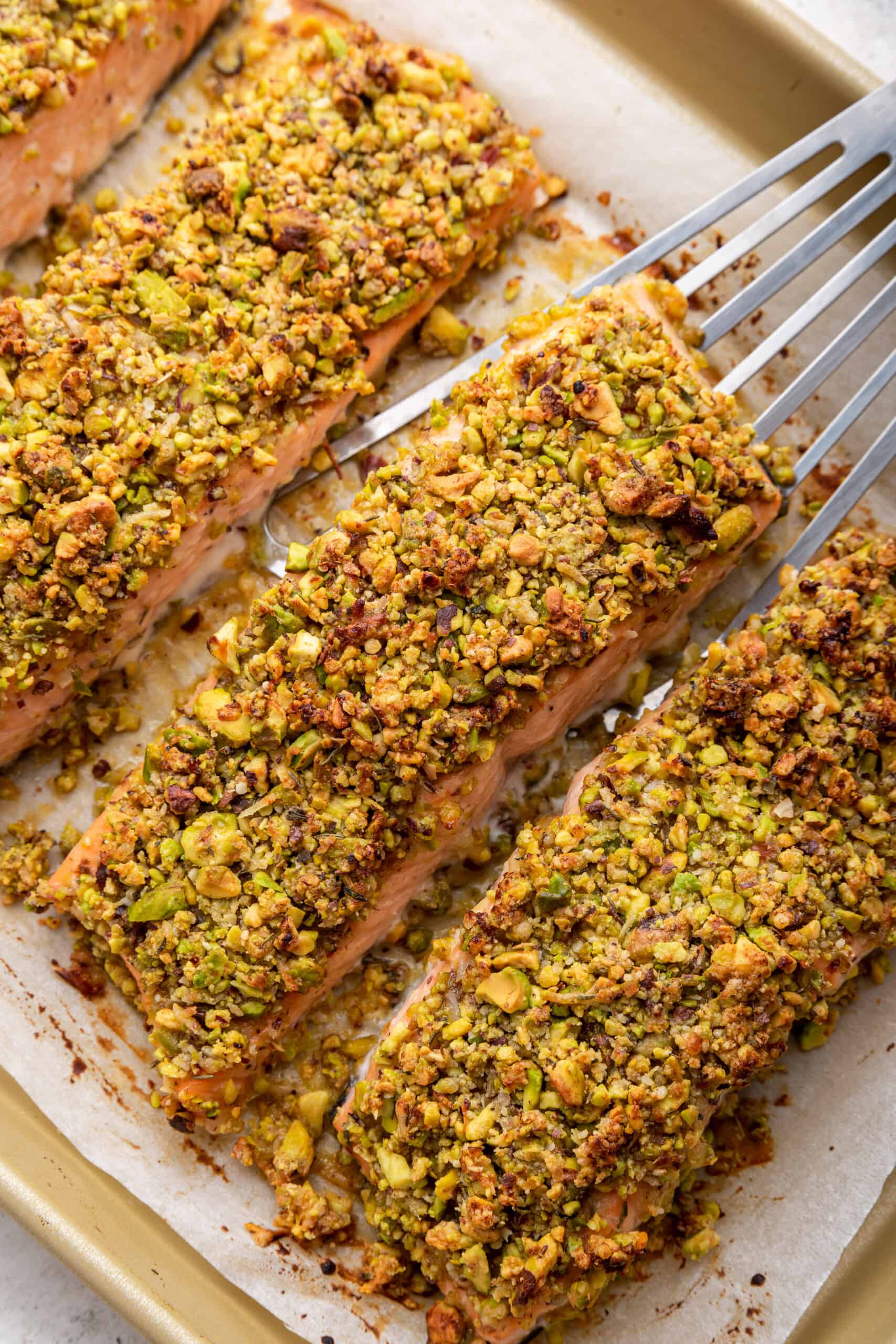 Spatula lifting pistachio crusted salmon fillet