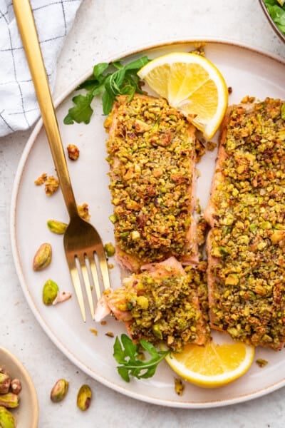 Overhead view of pistachio crusted salmon on plate with fork