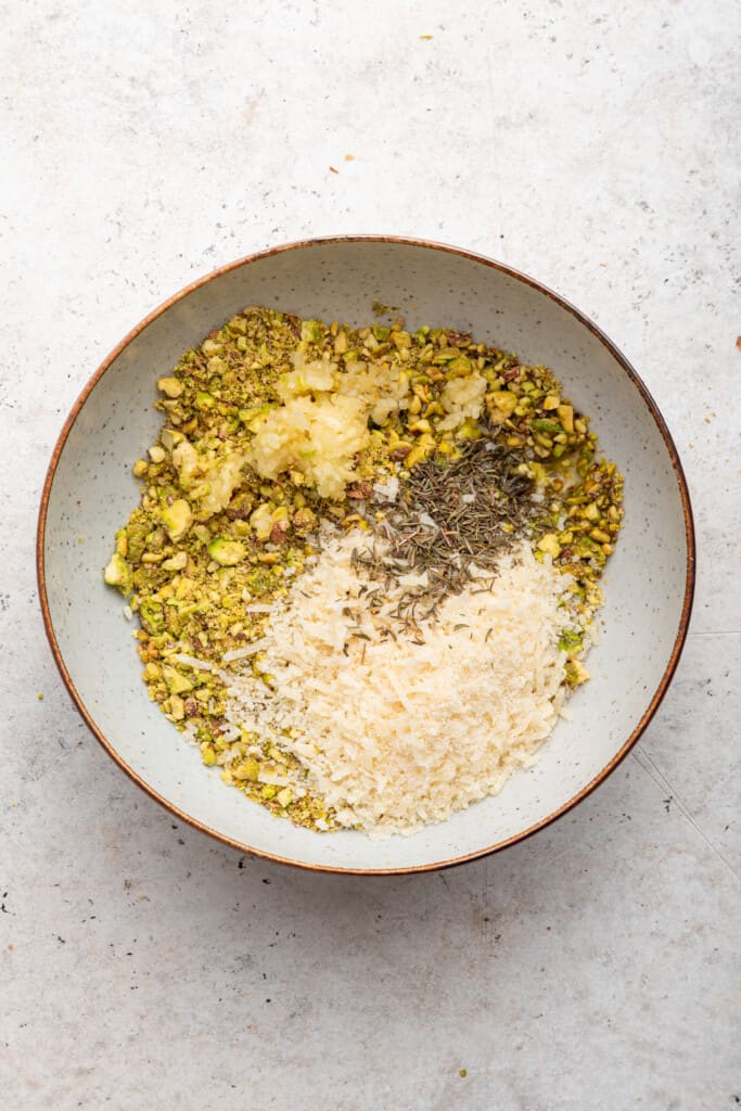 Overhead view of ingredients for pistachio crust in bowl