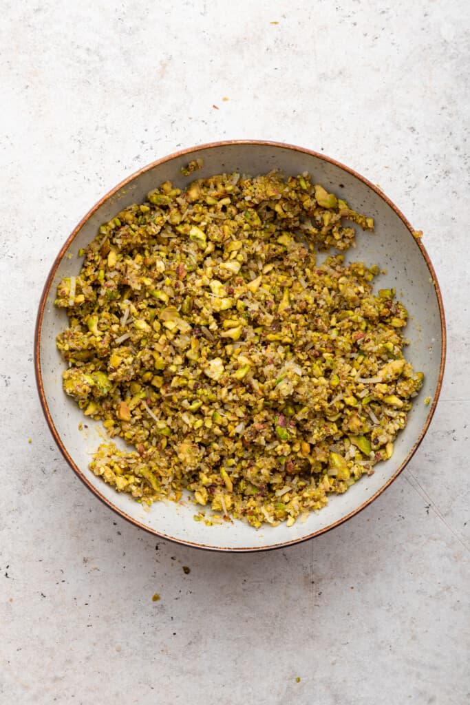 Overhead view of pistachio crust mixture in bowl