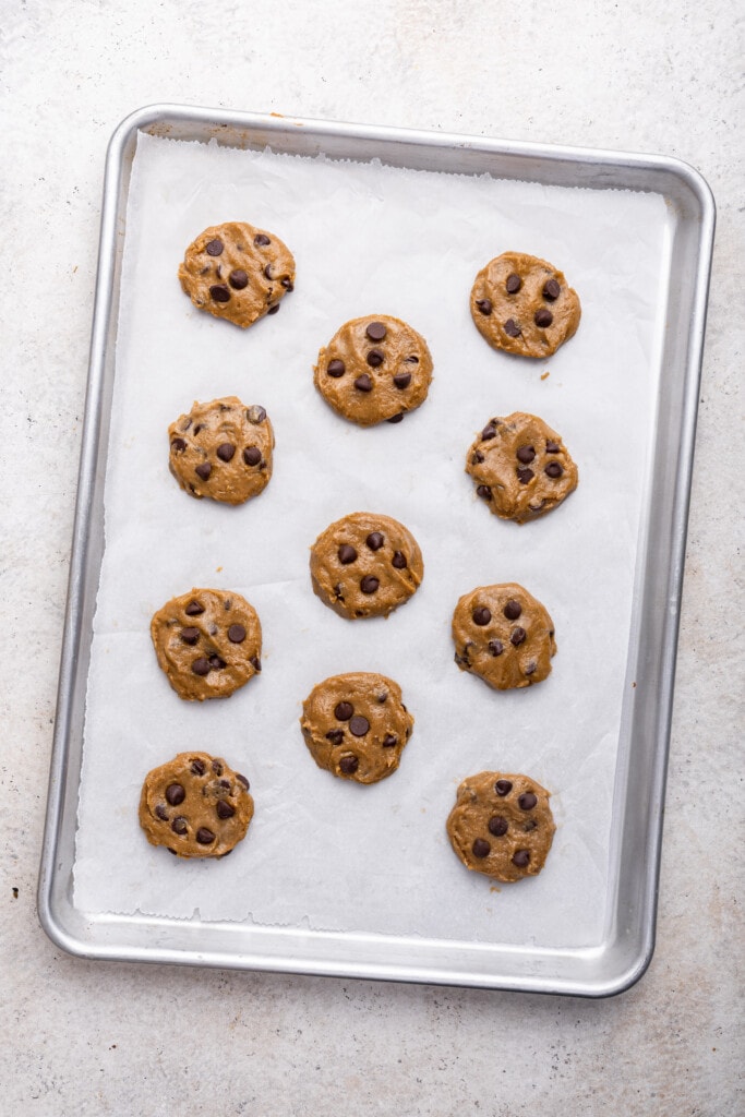 Overhead view of tahini chocolate chip cookies on pan before baking