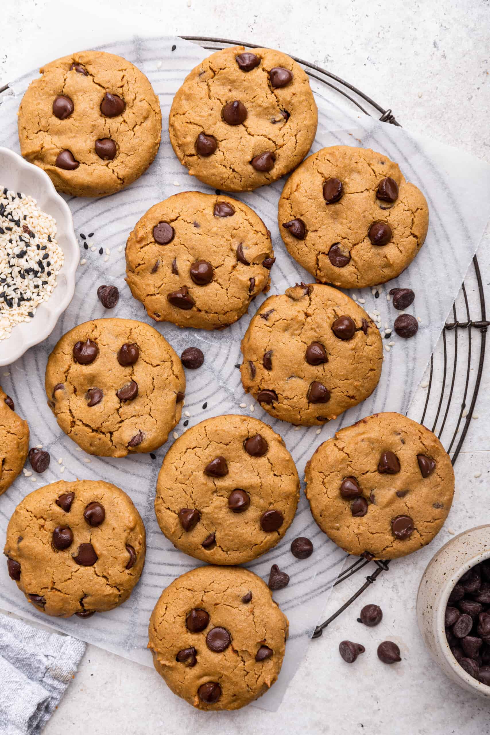 Overhead view of tahini chocolate chip cookies on parchment lined wire rack
