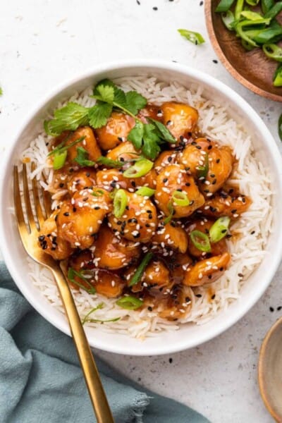 Overhead view of honey sriracha chicken piled onto white rice