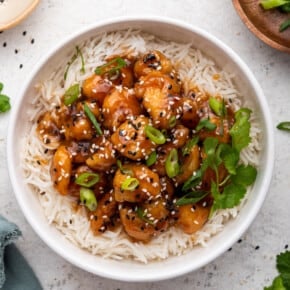 Sweet and spicy honey sriracha chicken in bowl with rice
