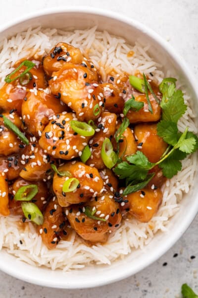 Overhead view of sticky honey sriracha chicken with rice in bowl