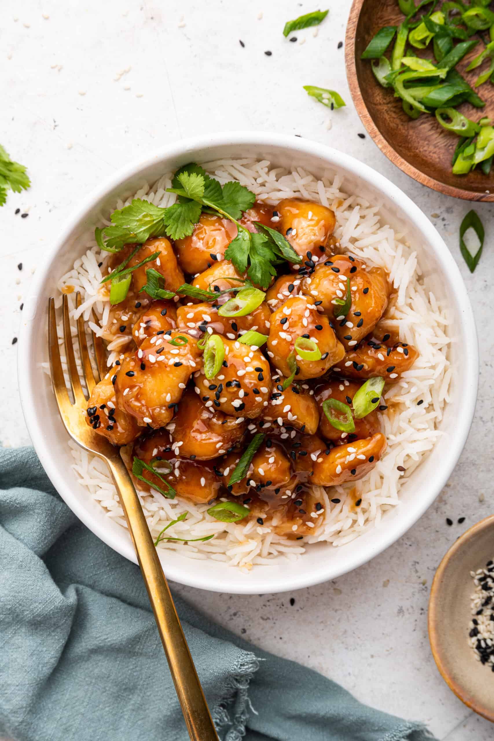 Overhead view of honey sriracha chicken piled onto white rice