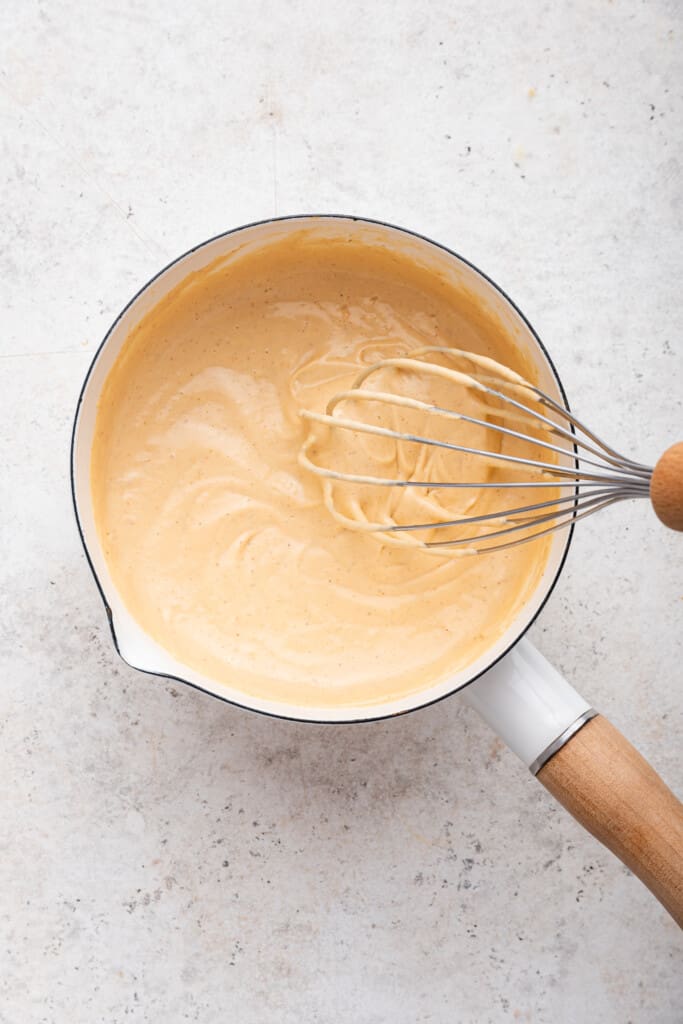 Whisking vegan queso in saucepan