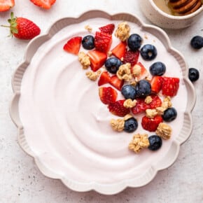 Bowl of whipped cottage cheese garnished with fruit and granola