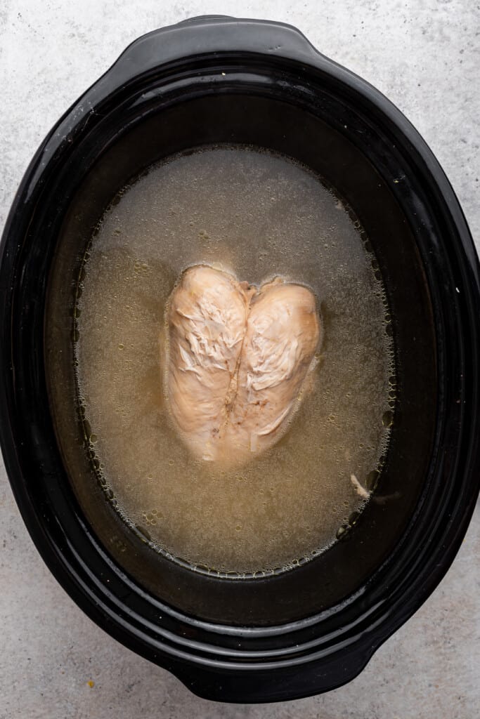 Cooked chicken in crockpot with ginger ale