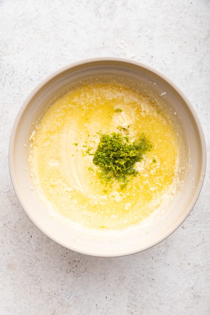 Overhead view of lime zest and juice added to cake batter