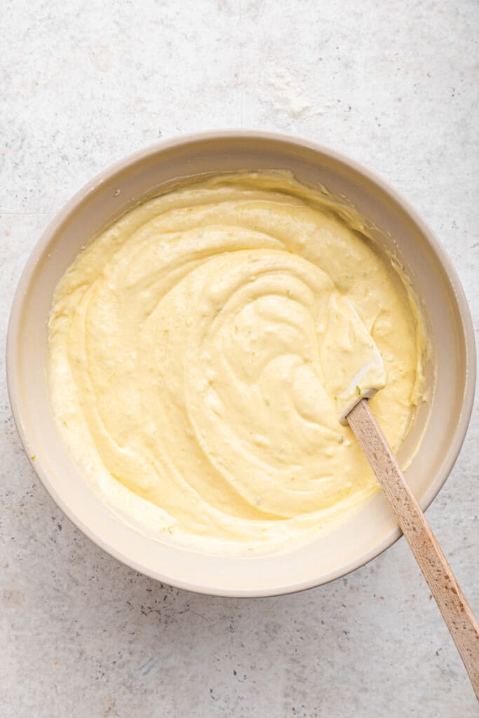 Overhead view of key lime cake batter in mixing bowl