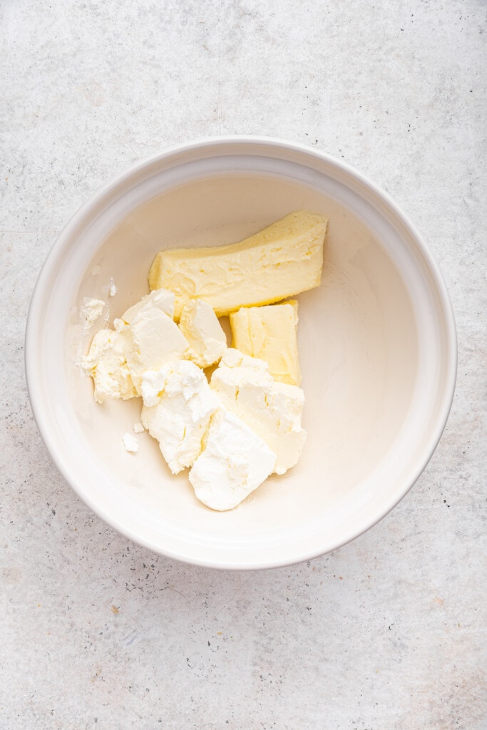 Cream cheese and butter in mixing bowl
