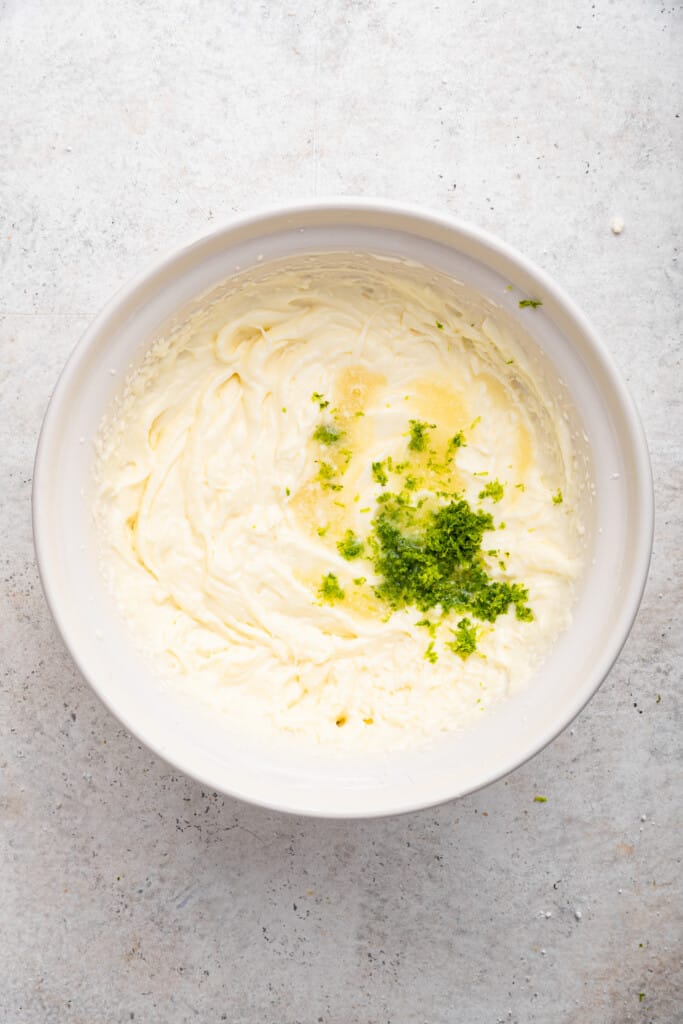 Lime zest and juice added to bowl of frosting