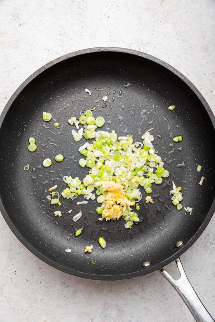 Cooking green onion and garlic in skillet