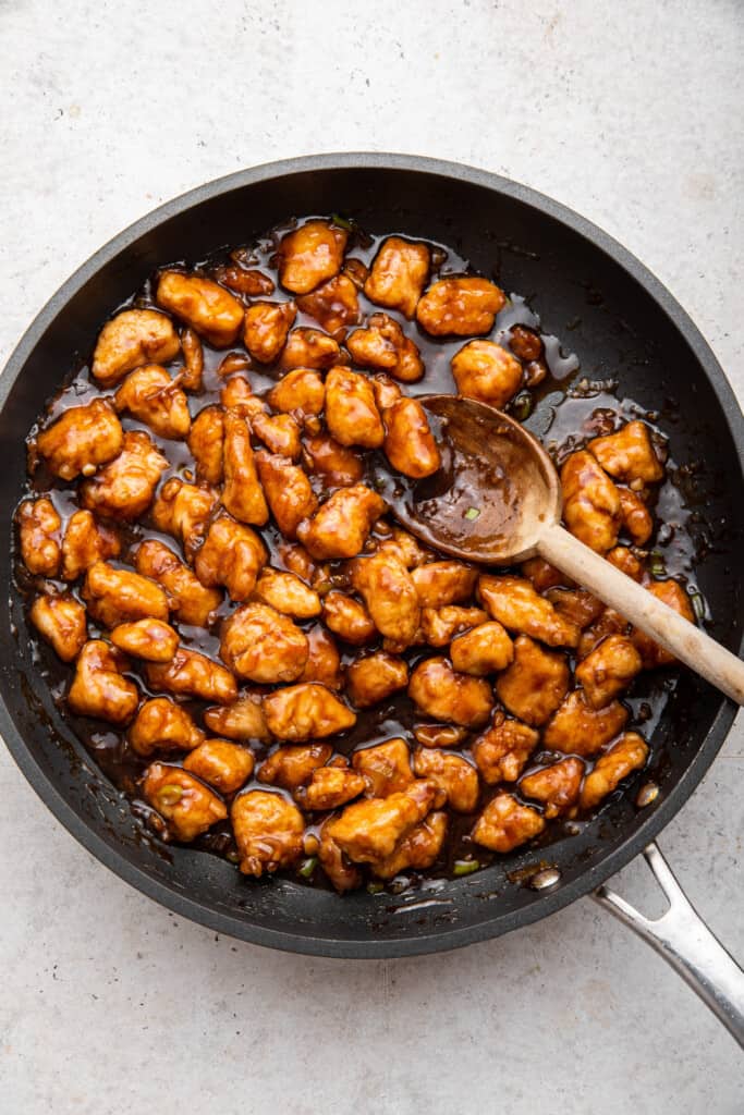 Spoon stirring skillet of Mongolian chicken