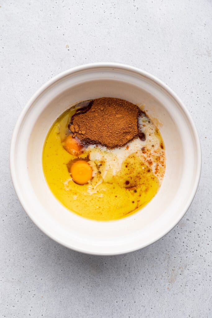 Overhead view of wet ingredients for carrot bread in bowl before mixing