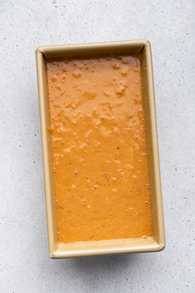 Overhead view of carrot bread batter in pan before adding toppings