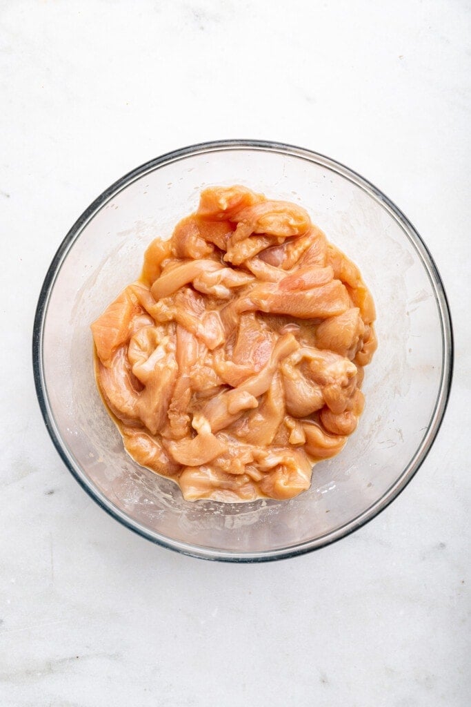 Overhead view of chicken and marinade in bowl