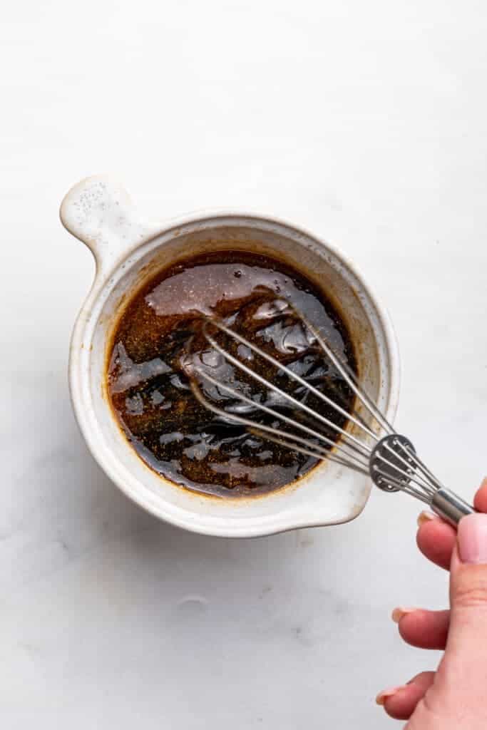 Overhead view of sauce in bowl with whisk