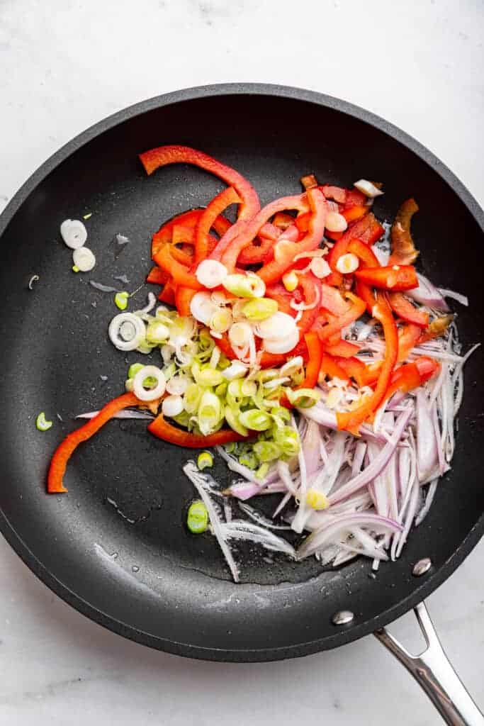 Shallots, red pepper, and scallions in skillet