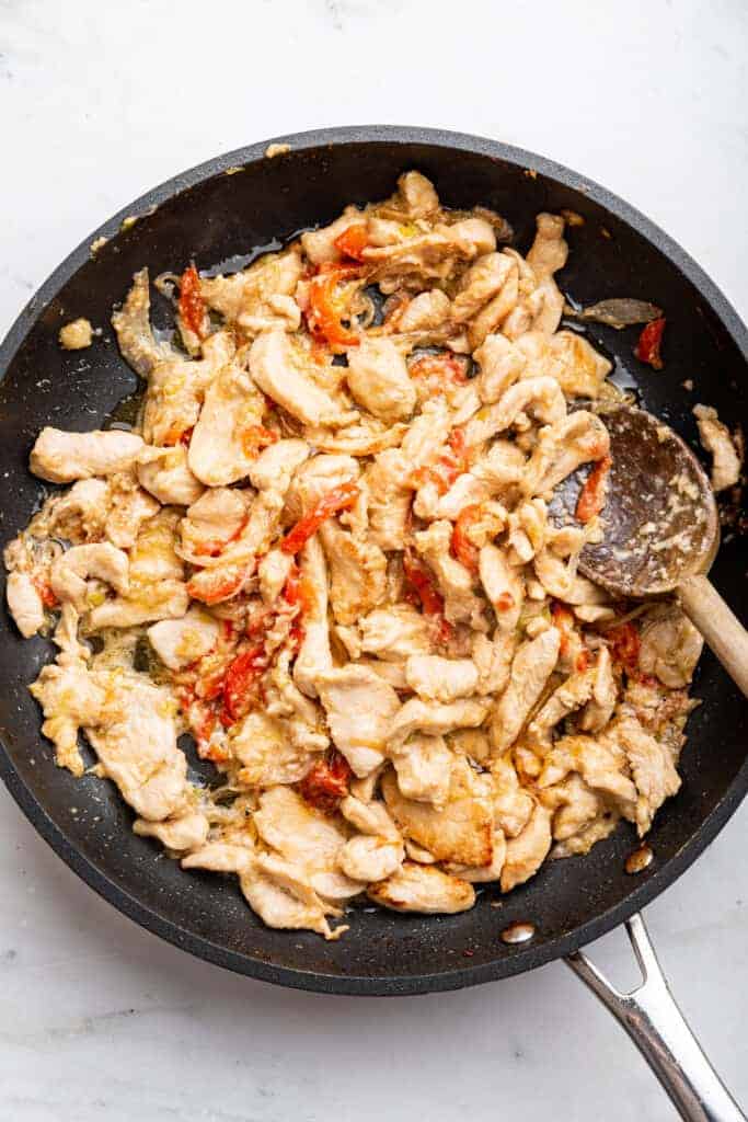 Stir fried chicken and vegetables in skillet