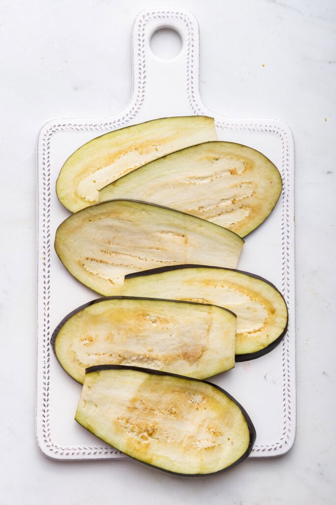 Overhead view of sliced eggplant on board