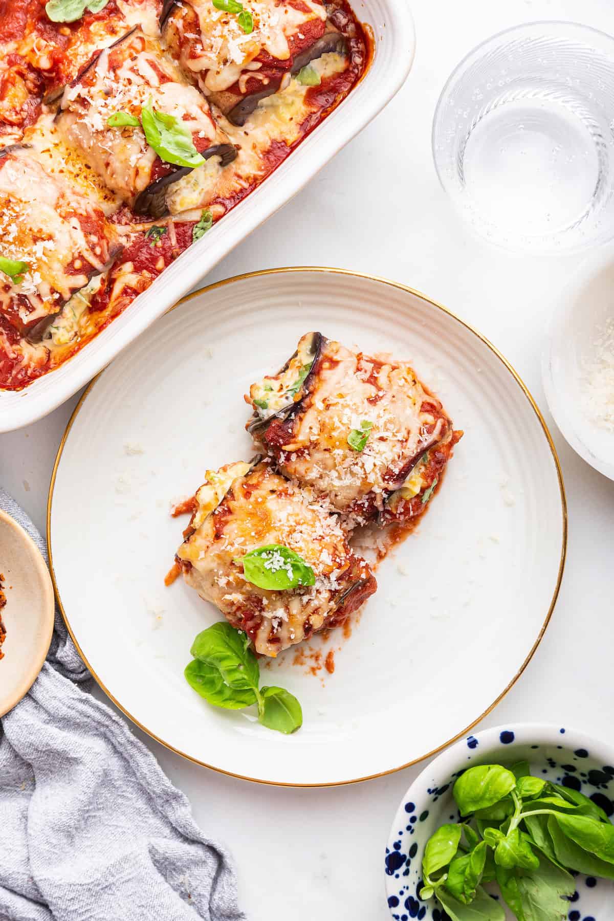 Overhead view of two eggplant rollatini on plate