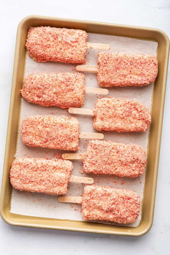 Overhead view of strawberry shortcake ice cream bars on sheet pan