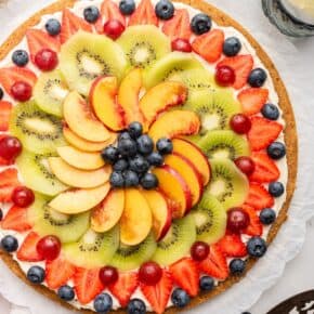 Overhead view of whole fruit pizza on platter