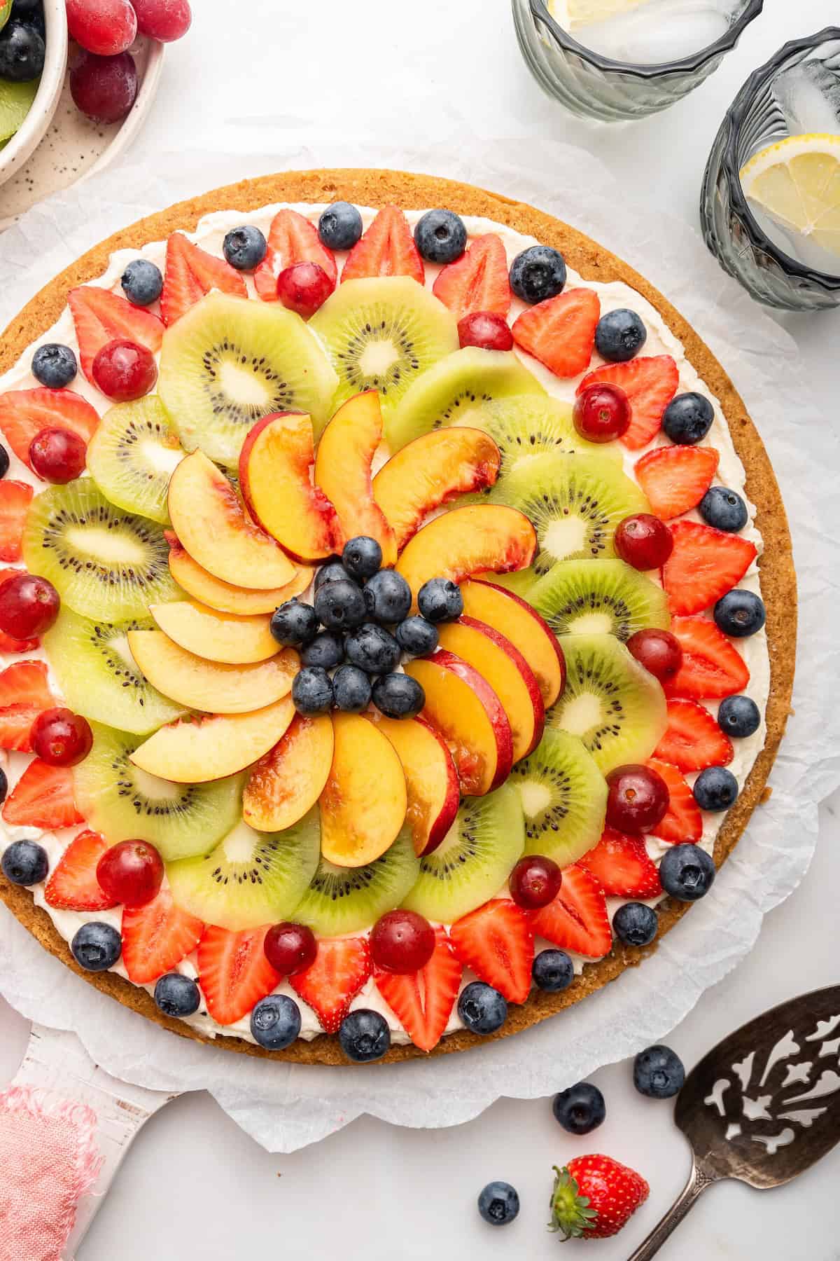 Overhead view of whole fruit pizza on platter