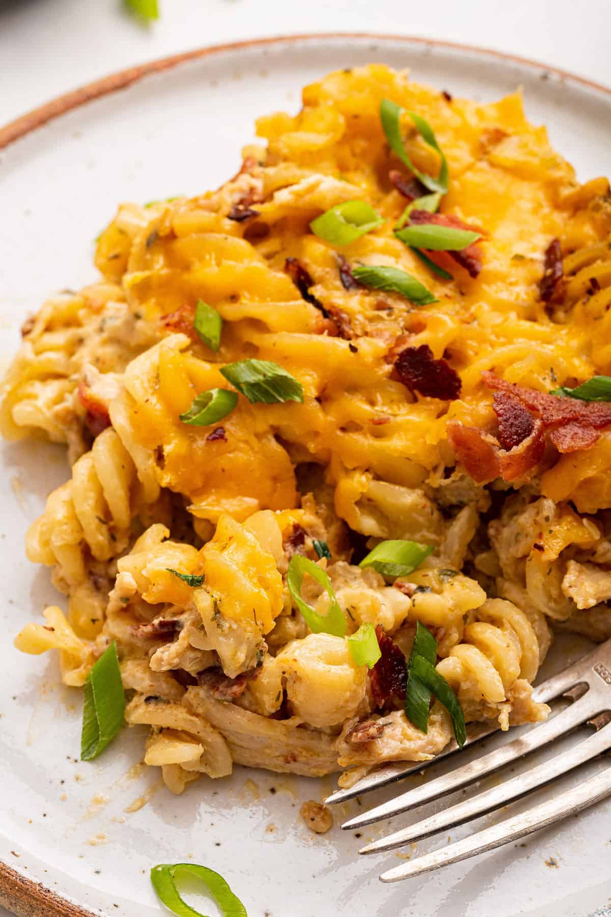 With bacon, juicy chicken, pasta, lots of cheese, and a creamy ranch sauce, it’s easy to see why this crack chicken casserole is so addictive! Crack chicken casserole on plate