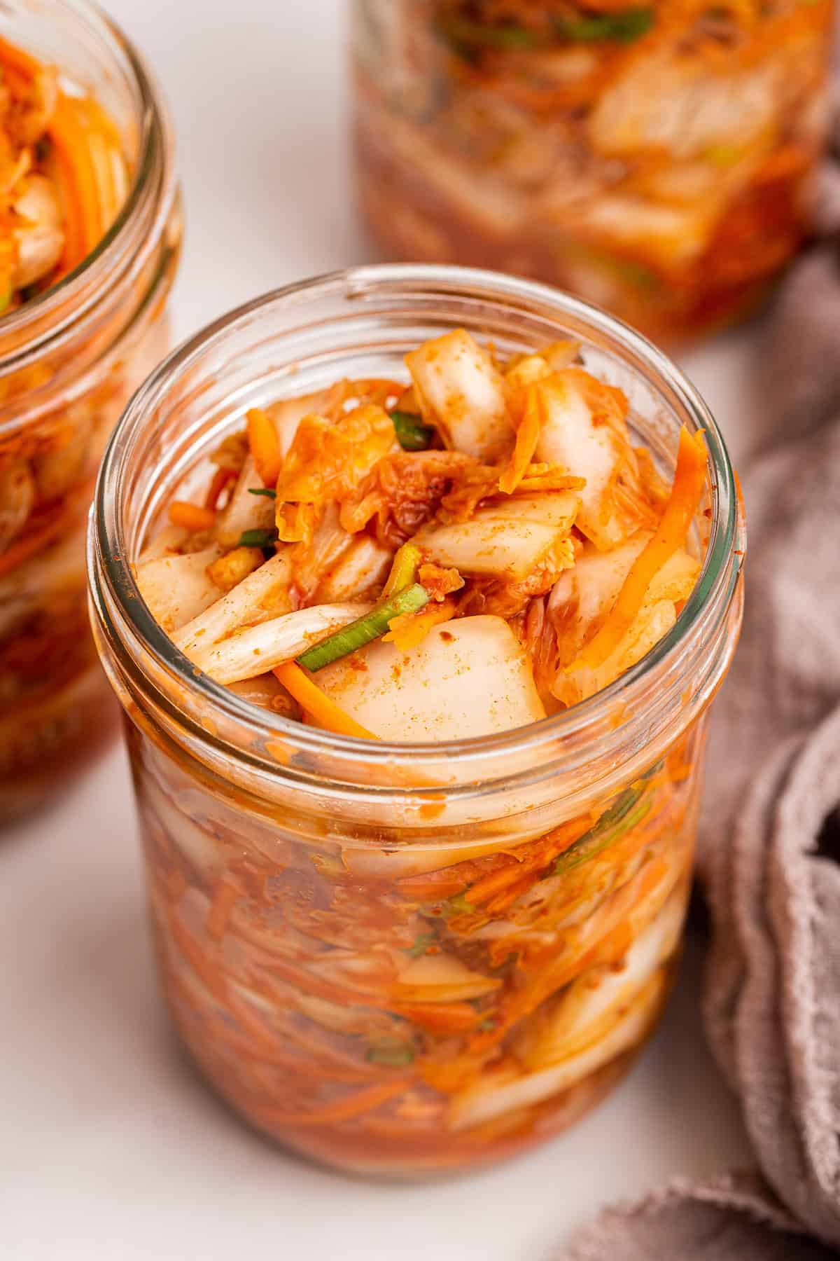 Making your own kimchi is easier than you think! This step-by-step kimchi recipe is delicious, customizable, and packed with probiotics. Jar of homemade kimchi