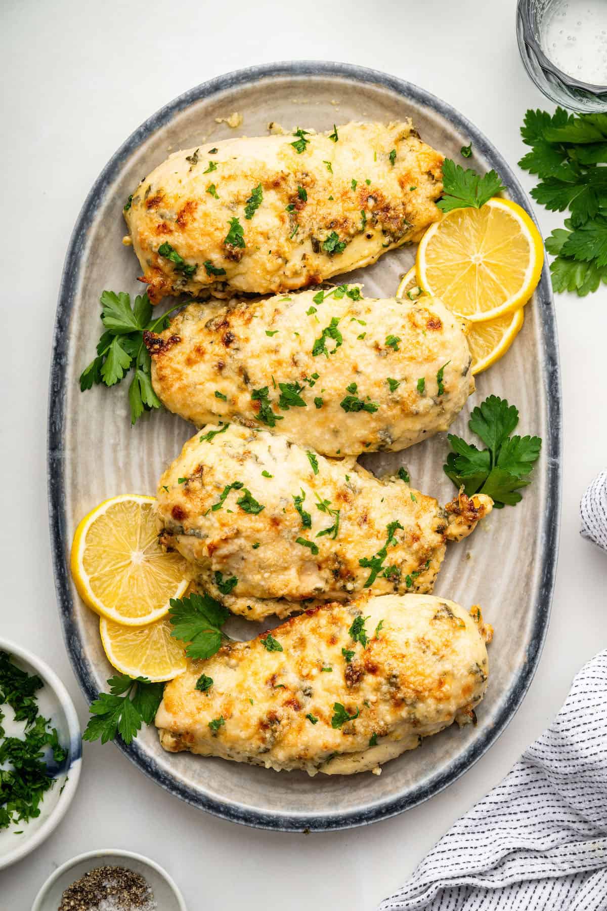 This Italian dressing chicken is marinated in a simple homemade dressing, then topped with cheese and baked until bubbly. An easy dinner idea! Italian Dressing Chicken on a serving platter.