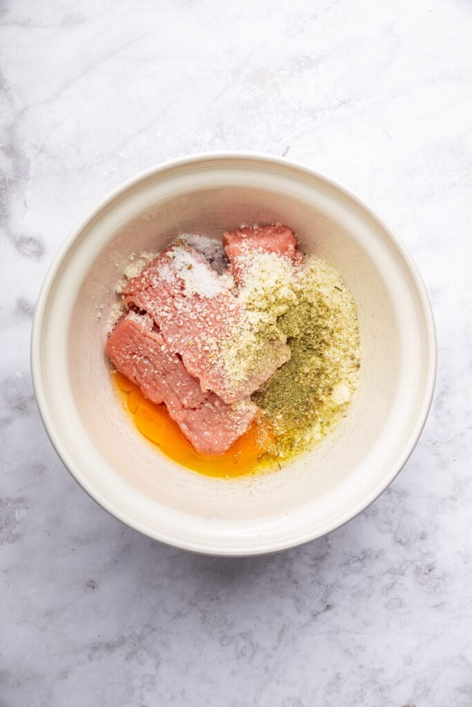 Ingredients for turkey meatballs in mixing bowl