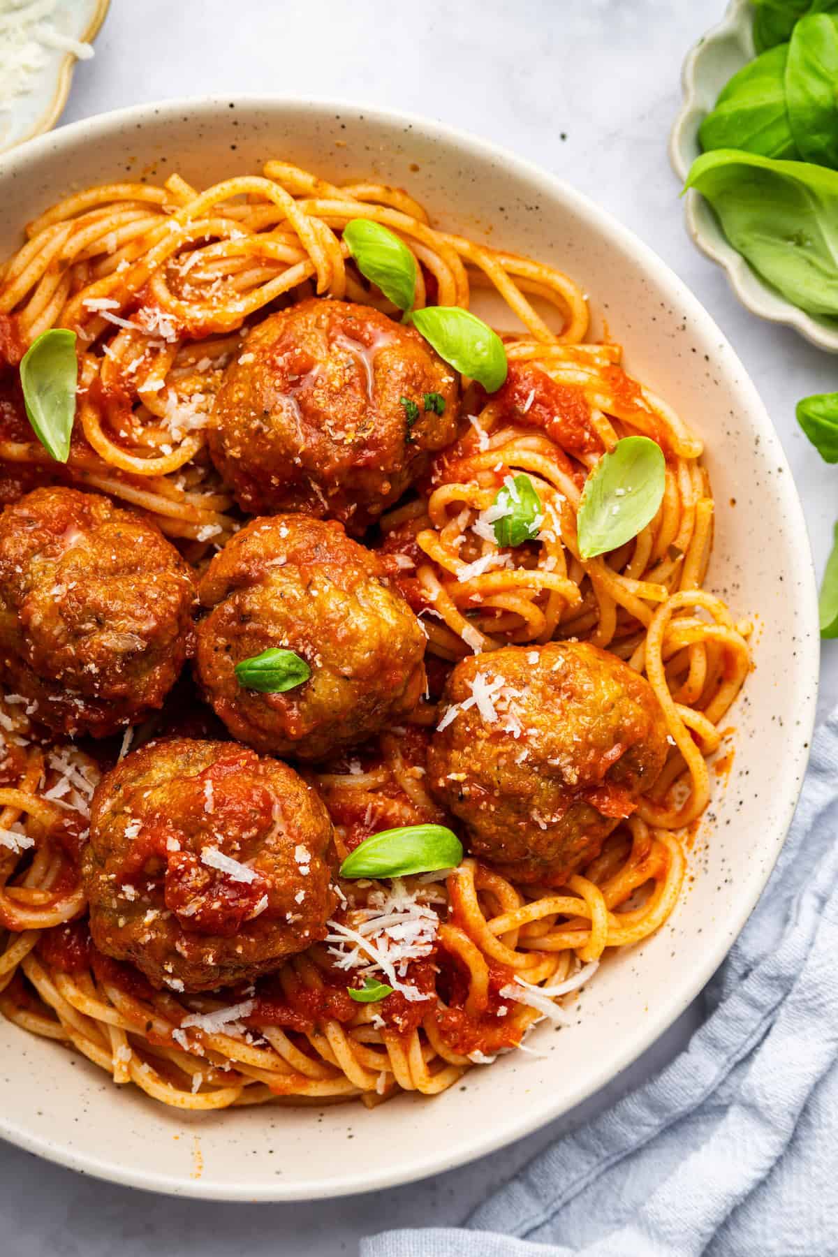 Spaghetti is even better with these Italian-style air fryer turkey meatballs! Juicy, perfectly seasoned, and SO quick and easy to make. Air fryer turkey meatballs in bowl of spaghetti