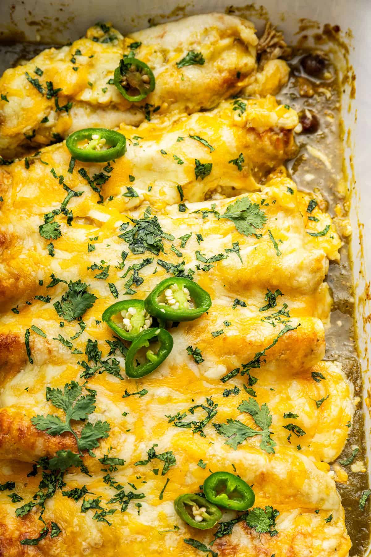 Green chicken enchiladas in pan