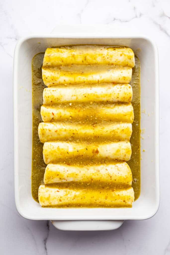 Enchiladas in pan with sauce before adding cheese