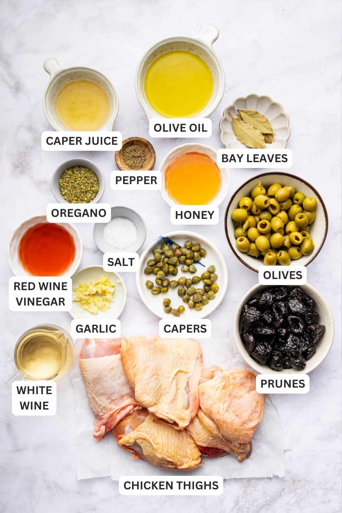 Overhead view of ingredients for chicken marbella with labels