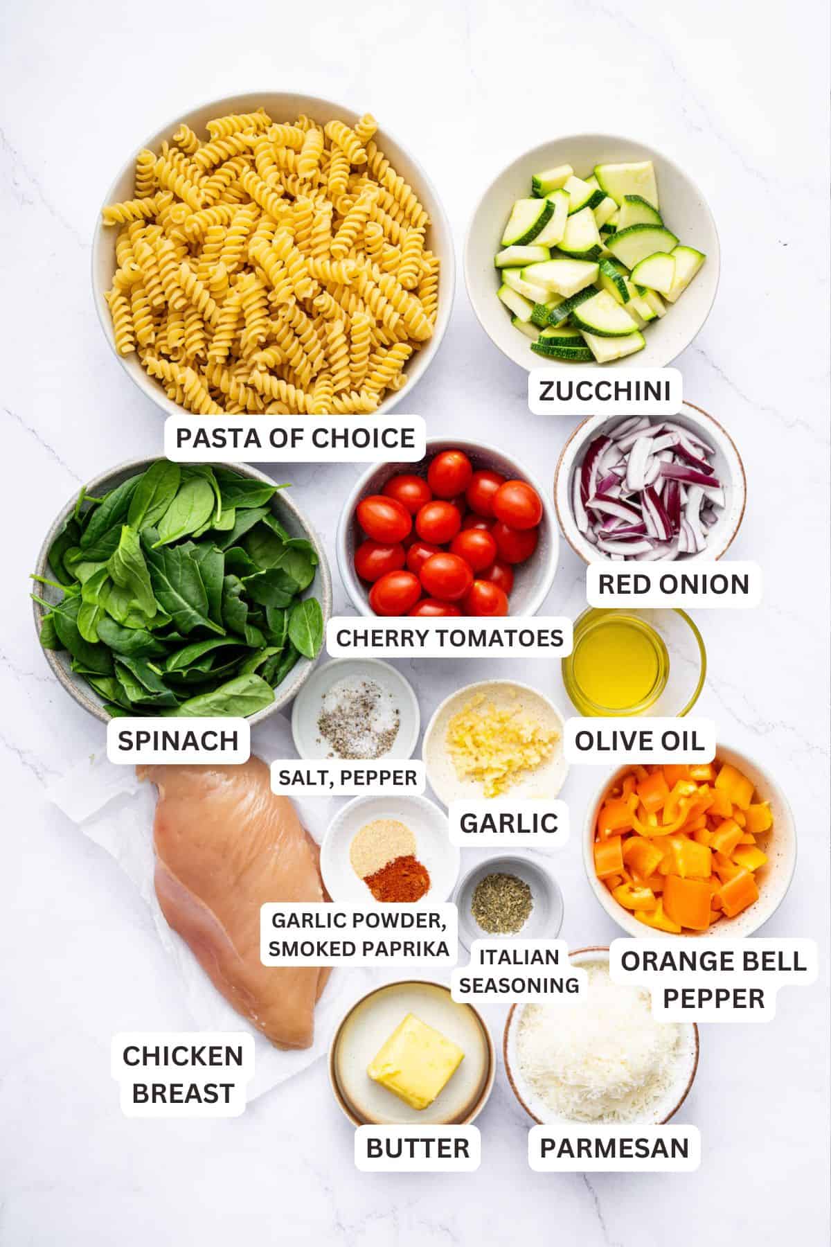 Overhead view of ingredients for chicken pasta primavera