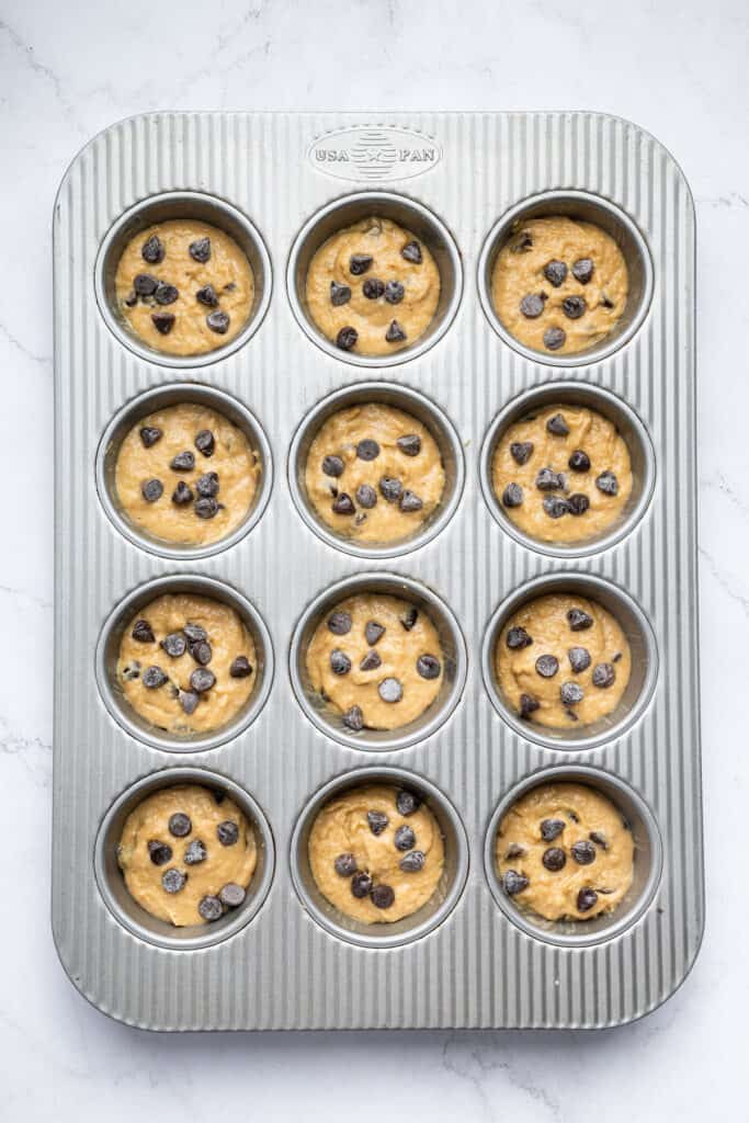 Overhead view of banana protein muffin batter in pan